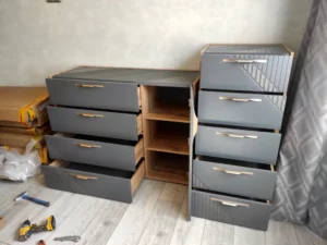 Partially assembled drawer units with tools and packaging during handyman furniture setup in Toronto